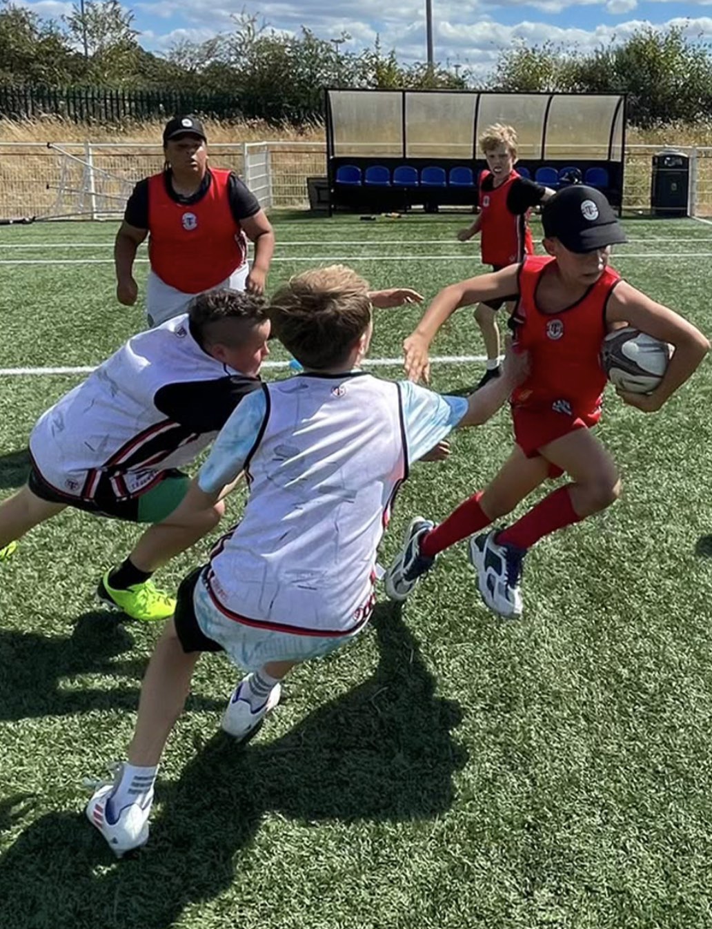 A Junior Camp player breaking through two defenders